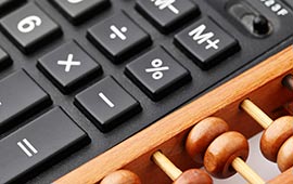 Calculator and abacus close up.